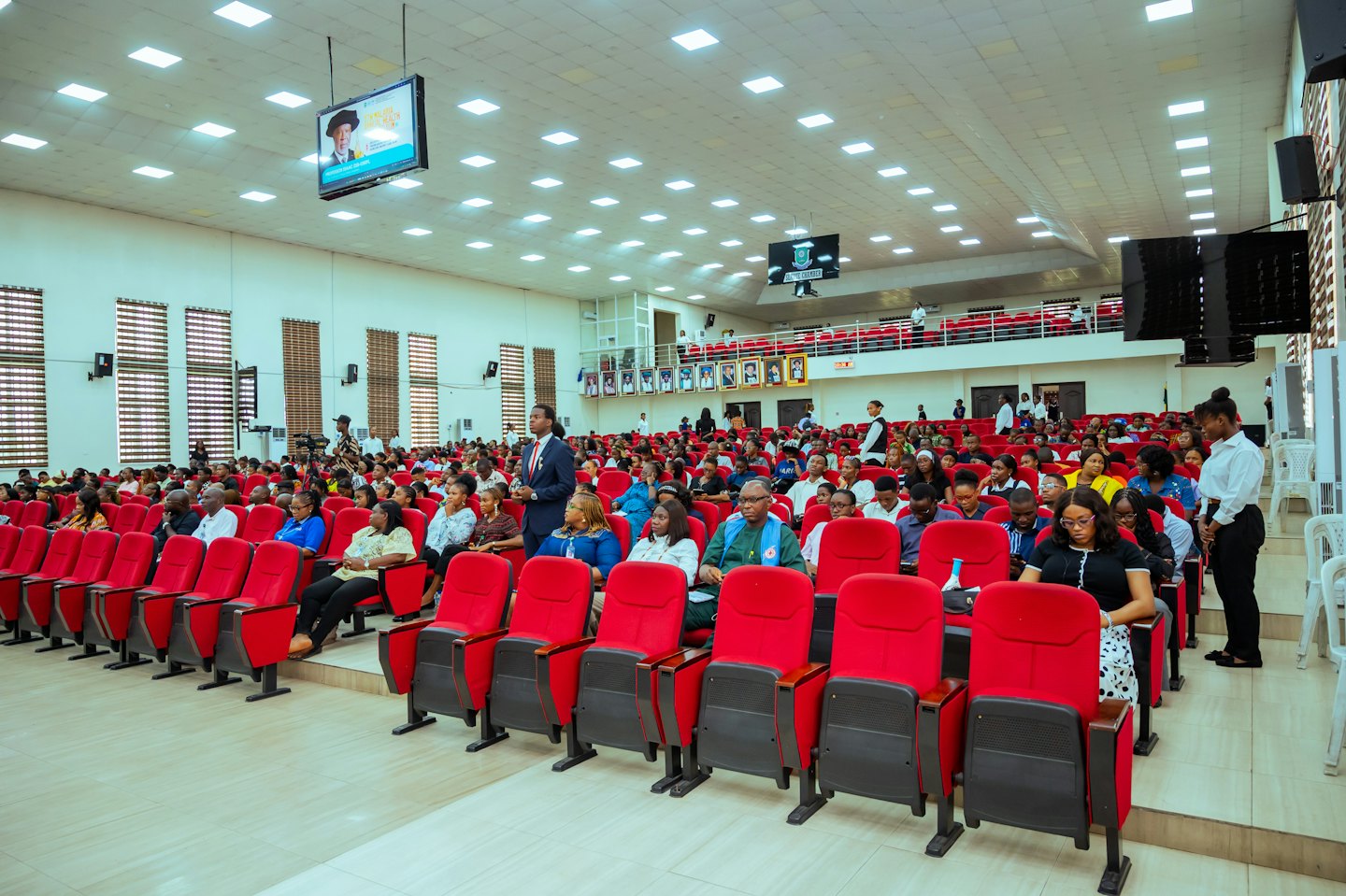 People sitting in an auditorium for a leadership seminar.